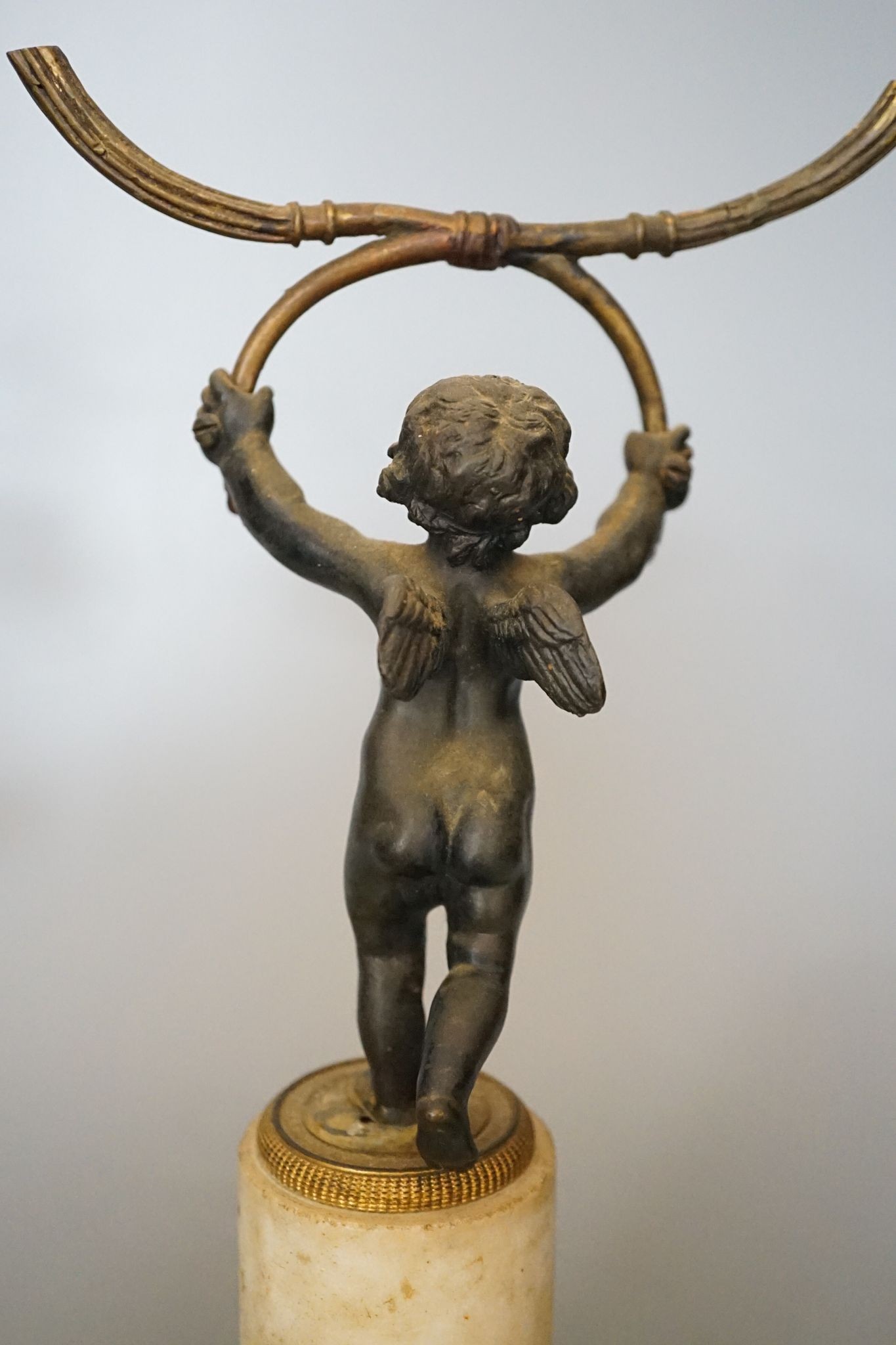 A pair of 19th century bronze and ormolu cherub candelabra, on alabaster plinths, 33cm